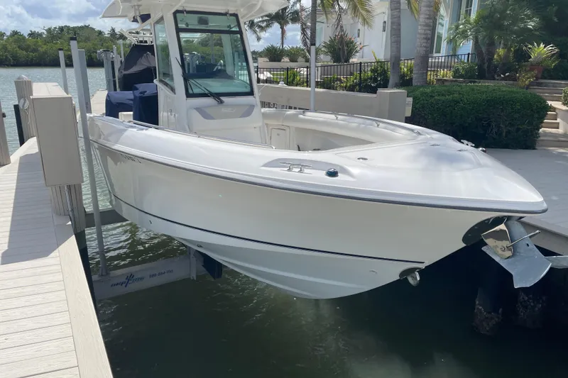 Slide: The Image of 2009 Boston Whaler 280 Outrage boat docked near waterfront home. - 3