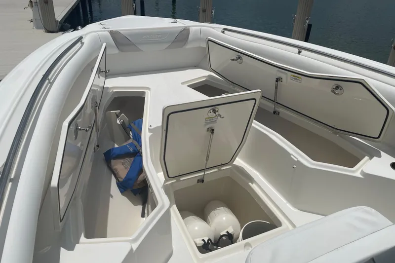 Slide: The Image of 2009 Boston Whaler 280 Outrage boat storage compartments open at dockside. - 30