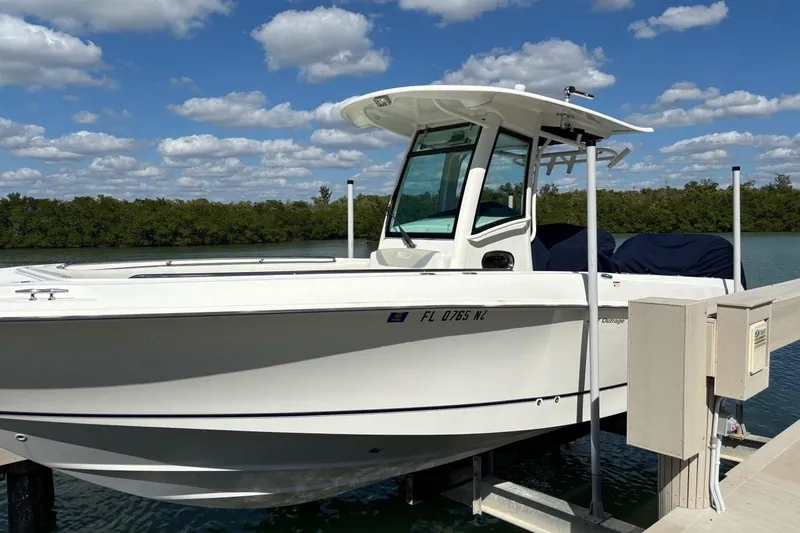 Slide: The Image of 2009 Boston Whaler 280 Outrage boat docked under a clear blue sky. - 35