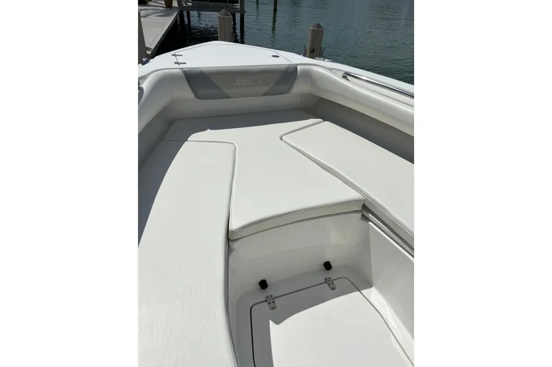 Slide: The Image of 2009 Boston Whaler 280 Outrage boat interior with white cushioned seating. - 36