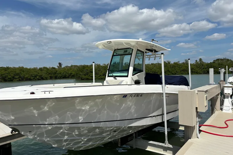 Slide: The Image of 2009 Boston Whaler 280 Outrage docked, under a clear blue sky. - 37