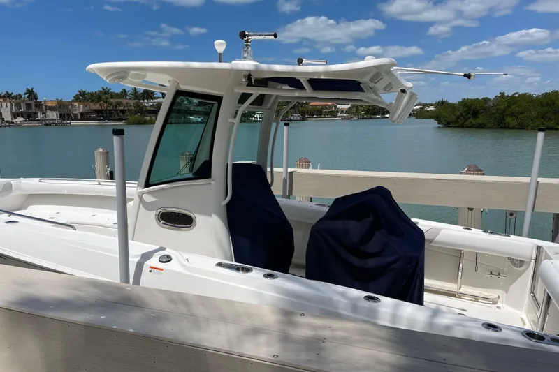 Slide: The Image of 2009 Boston Whaler 280 Outrage boat docked by serene waterfront. - 4