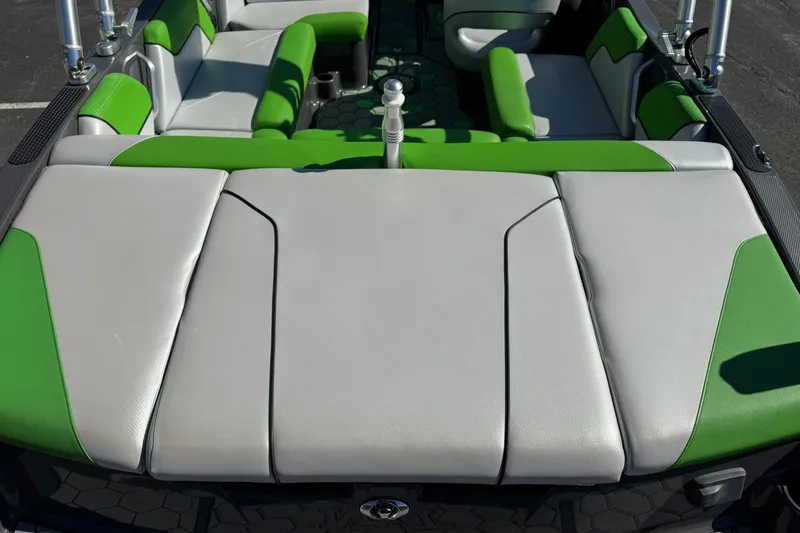 Slide: The Image of 2015 MasterCraft NXT20 boat interior with green and gray seating. - 11