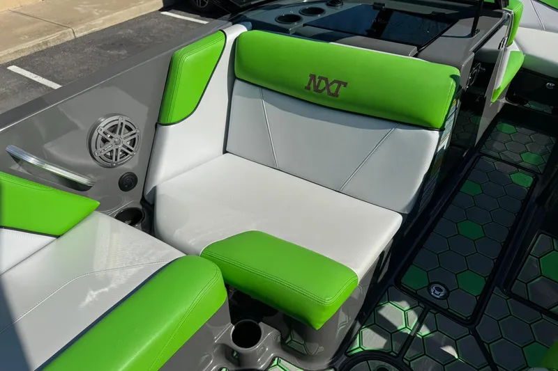 Slide: The Image of 2015 MasterCraft NXT20 boat interior with green and white seating. - 16