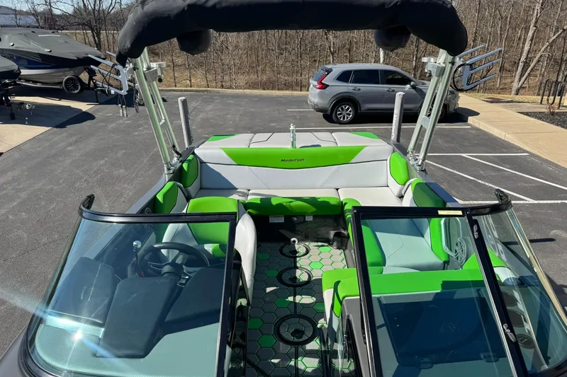 Slide: The Image of 2015 MasterCraft NXT20 boat with green and gray interior, parked outdoors. - 18