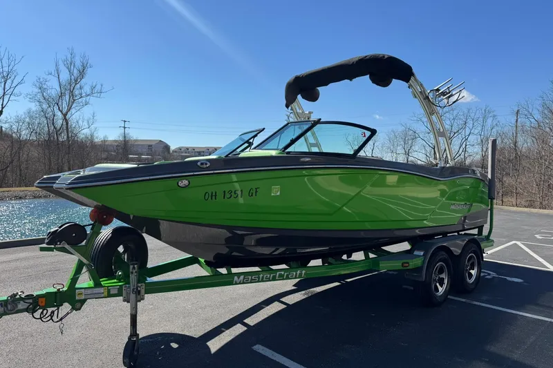 Slide: The Image of 2015 MasterCraft NXT20 boat in vibrant green on a matching trailer. - 8