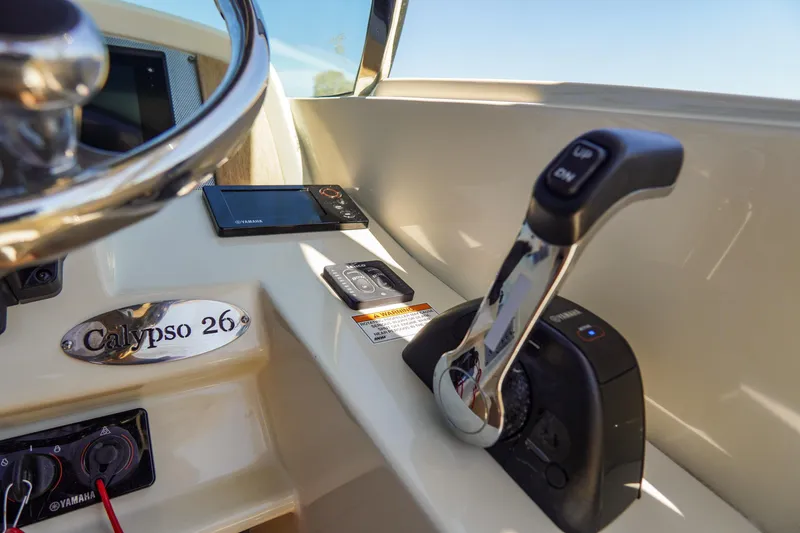 Slide: The Image of 2017 Chris-Craft Calypso 26 boat controls with Yamaha throttle and steering wheel. - 14