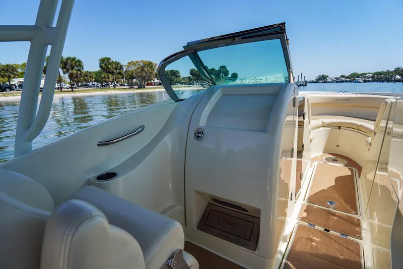 Slide: The Image of 2017 Chris-Craft Calypso 26 boat interior with seating and open water view. - 15