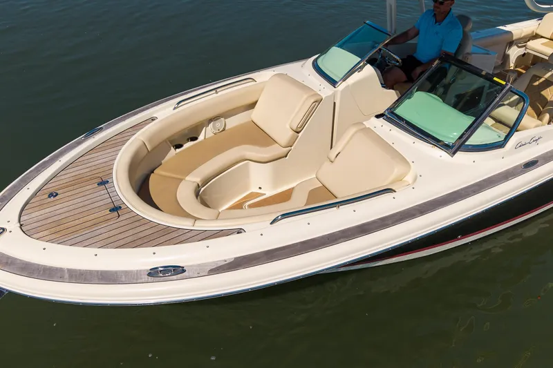 Slide: The Image of 2017 Chris-Craft Calypso 26 boat with elegant seating and teak deck on calm water. - 3