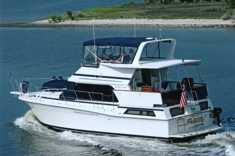 The Image of 1989 Chris Craft 427 yacht cruising on a serene waterway. - 0