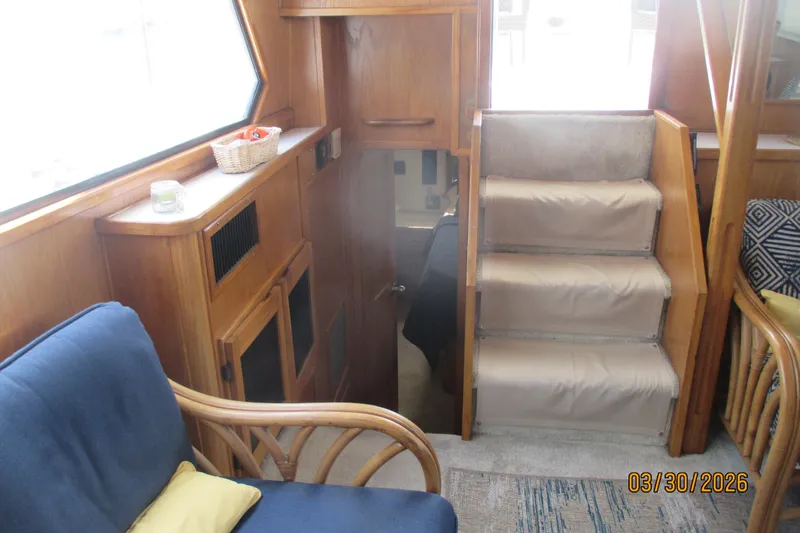 Slide: The Image of Interior of 1989 Chris Craft 427 yacht with wooden cabinetry and carpeted stairs. - 11