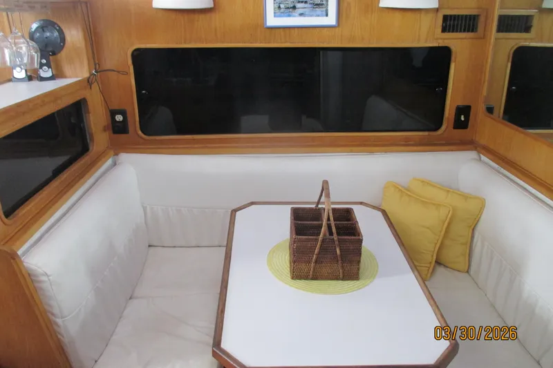 Slide: The Image of Interior of 1989 Chris Craft 427 yacht with cozy seating and wicker basket centerpiece. - 15