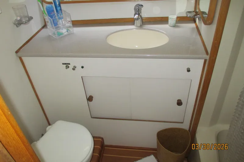Slide: The Image of Bathroom interior of 1989 Chris Craft 427 yacht with sink and toilet. - 26