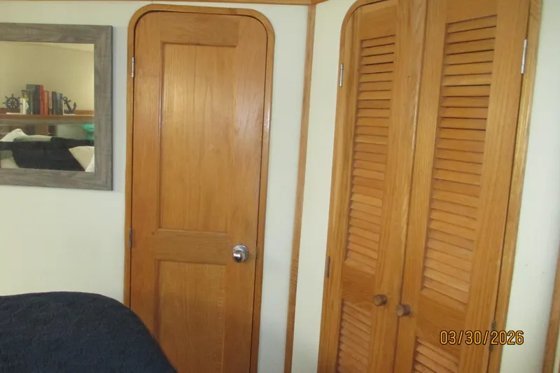 Slide: The Image of Interior of 1989 Chris Craft 427 with wooden doors and mirror reflection. - 30