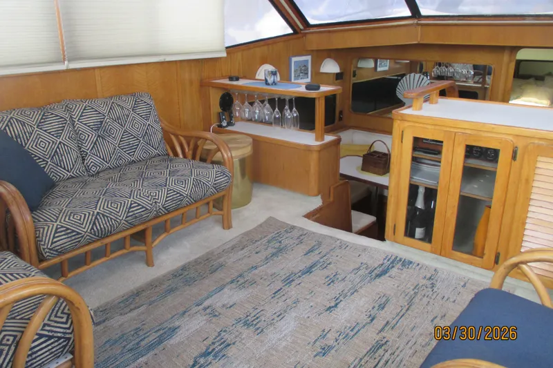 Slide: The Image of Interior of 1989 Chris Craft 427 yacht with cozy seating and wooden cabinetry. - 32