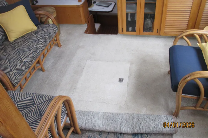 Slide: The Image of Interior of 1989 Chris Craft 427 Catalina with cozy seating and carpeted flooring. - 33