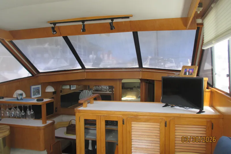 Slide: The Image of Interior of a 1989 Chris Craft 427 yacht with wooden cabinetry and a TV. - 34