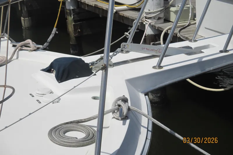 Slide: The Image of Bow of 1989 Chris Craft 427 yacht docked, featuring ropes and anchor. - 39