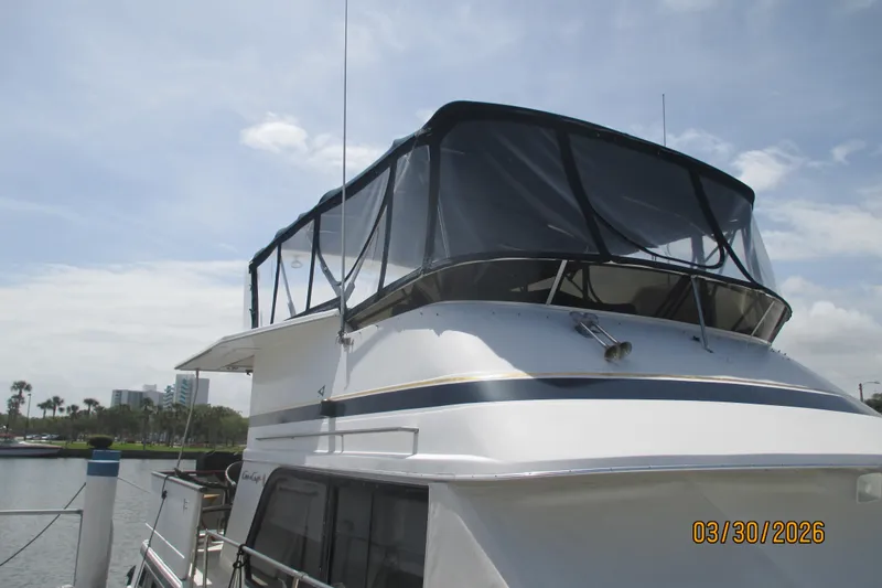 Slide: The Image of 1989 Chris Craft 427 yacht docked under a clear sky. - 40