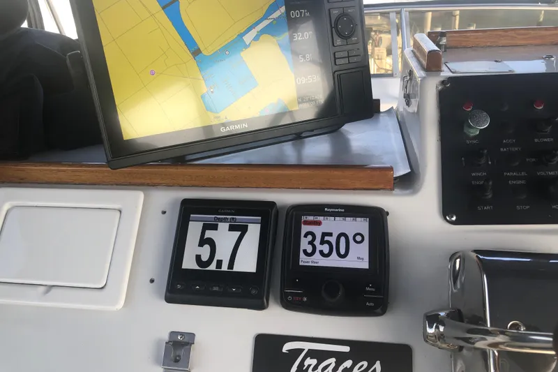 Slide: The Image of Dashboard of a 1989 Chris Craft 427 with navigation and depth displays. - 41