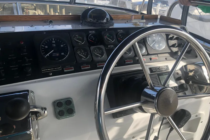 Slide: The Image of Helm of 1989 Chris Craft 427 boat with gauges and steering wheel. - 42