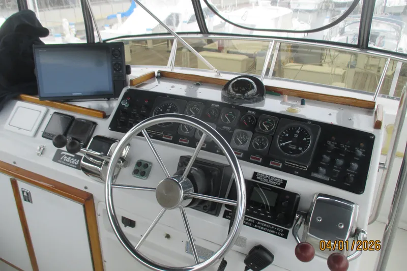 Slide: The Image of Helm of 1989 Chris Craft 427 Catalina with steering wheel and navigation instruments. - 44