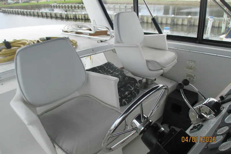 Slide: The Image of Interior helm of 1989 Chris Craft 427 Catalina with dual captain chairs and steering wheel. - 46