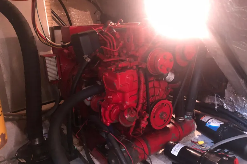 Slide: The Image of 1989 Chris Craft 427 engine in a boat's engine compartment, illuminated by bright light. - 47