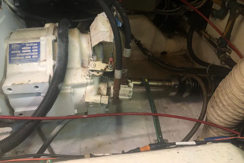 Slide: The Image of Engine compartment of a 1989 Chris Craft 427 boat, showing mechanical components and wiring. - 49