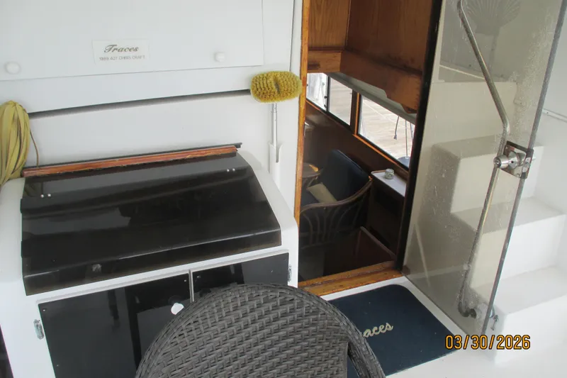 Slide: The Image of 1989 Chris Craft 427 yacht interior with seating, grill, and glass door. - 6