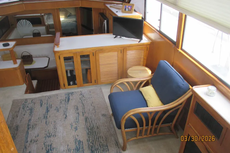 Slide: The Image of Interior of 1989 Chris Craft 427 yacht with cozy seating and wooden cabinetry. - 8