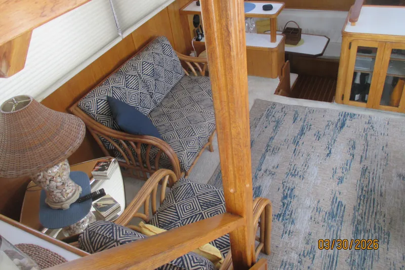 Slide: The Image of Interior of 1989 Chris Craft 427 yacht with patterned seating and wooden accents. - 9
