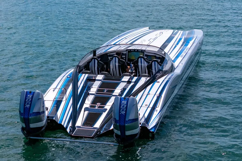 Slide: The Image of 2024 MTI 440X powerboat with dual engines on clear blue water. - 2