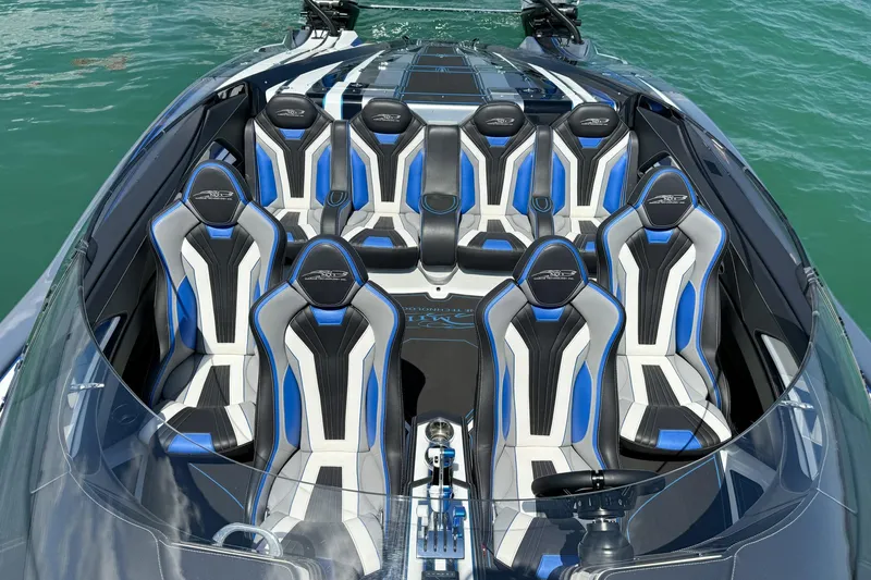 Slide: The Image of Luxurious 2024 MTI 440X boat interior with sleek blue and white seating on water. - 3