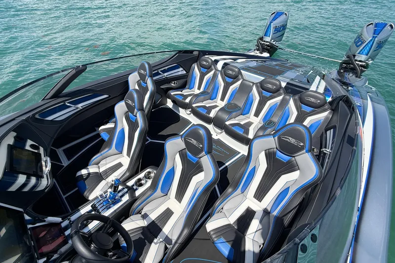 Slide: The Image of 2024 MTI 440X boat interior with sleek, modern seating and advanced controls on water. - 4