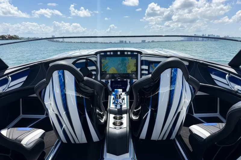 Slide: The Image of 2024 MTI 440X boat cockpit with dual seats, navigation display, and ocean view. - 6