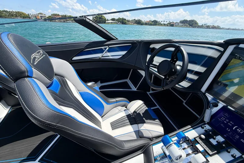 Slide: The Image of Interior of 2024 MTI 440X boat, featuring sleek steering and modern controls. - 8