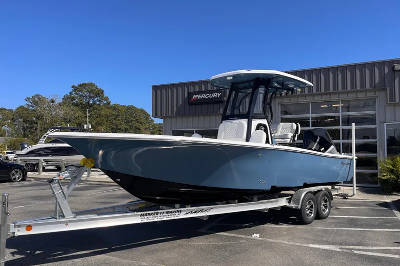 Slide: The Image of 2026 Tidewater 2500 Carolina Bay boat on trailer outside dealership. - 1