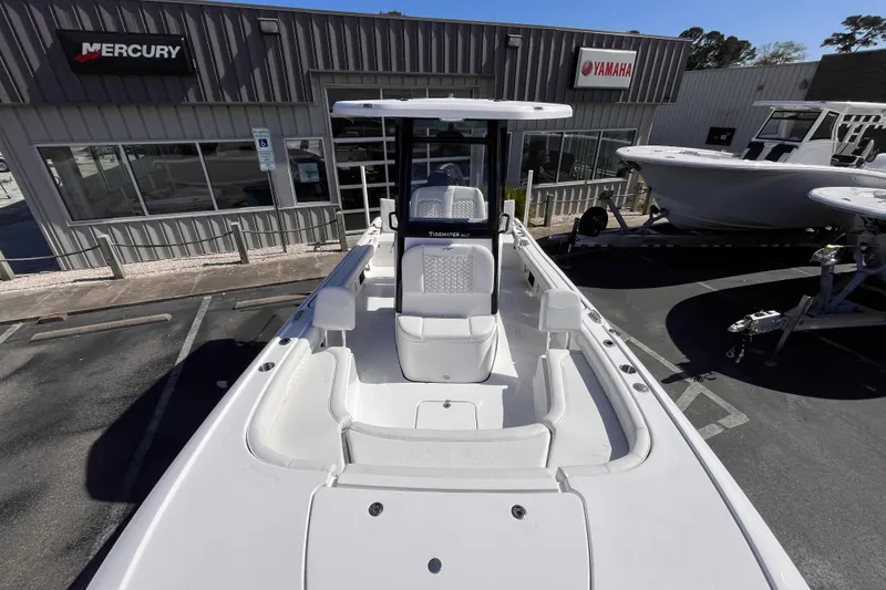 Slide: The Image of 2026 Tidewater 2500 Carolina Bay boat displayed at dealership with Mercury and Yamaha signage. - 10