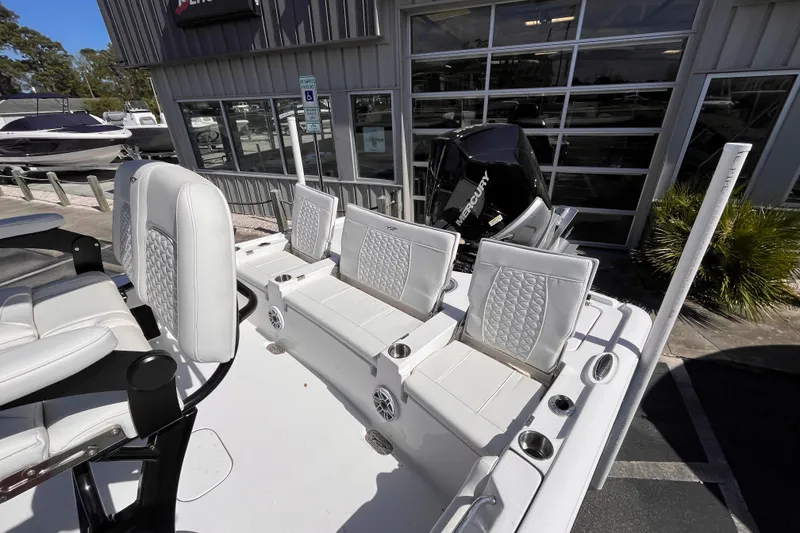 Slide: The Image of 2026 Tidewater 2500 Carolina Bay boat with white seating and Mercury engine. - 14