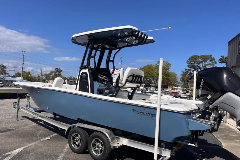 Slide: The Image of 2026 Tidewater 2500 Carolina Bay boat on trailer under clear blue sky. - 2
