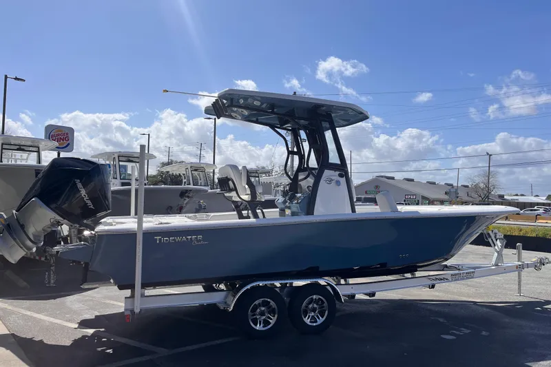 Slide: The Image of 2026 Tidewater 2500 Carolina Bay boat on trailer under clear blue sky. - 3