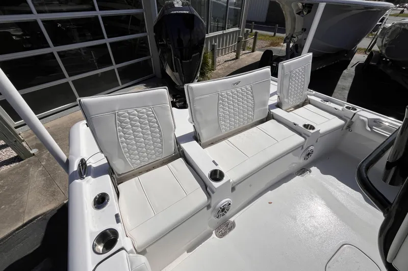 Slide: The Image of 2026 Tidewater 2500 Carolina Bay boat with white cushioned seating and cup holders. - 5