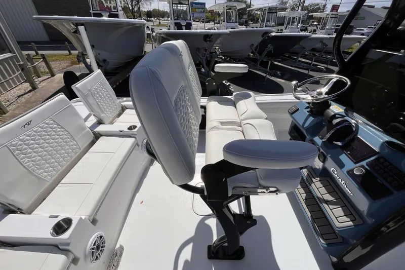 Slide: The Image of 2026 Tidewater 2500 Carolina Bay boat interior with modern seating and steering console. - 6