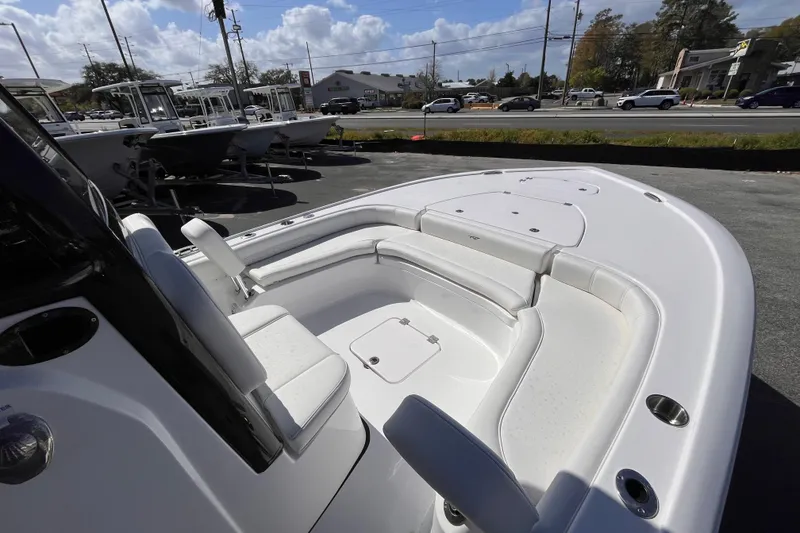 Slide: The Image of 2026 Tidewater 2500 Carolina Bay boat with spacious seating, parked outdoors. - 9