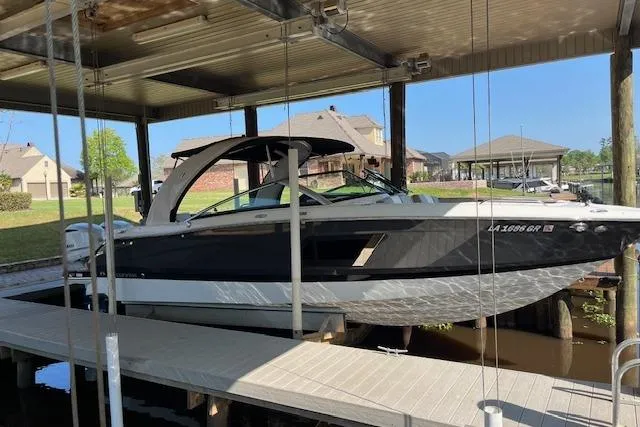 The Image of 2020 Four Winns H290 OB boat docked under a covered marina. - 1
