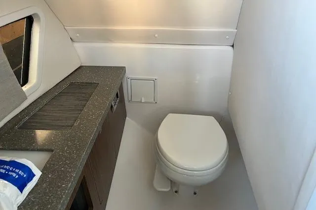 Slide: The Image of 2020 Four Winns H290 OB boat bathroom with toilet and countertop. - 10
