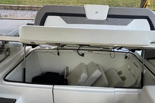 Slide: The Image of Open storage compartment on a 2020 Four Winns H290 OB boat. - 6
