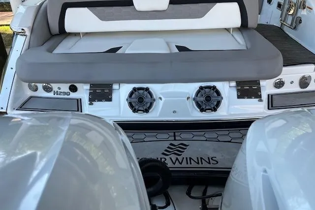 Slide: The Image of 2020 Four Winns H290 OB boat interior with speakers and seating. - 9