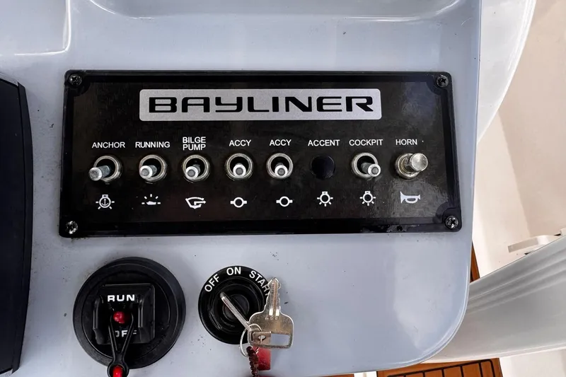 Slide: The Image of Control panel of 2023 Bayliner Trophy T20CC boat with switches and ignition keys. - 10